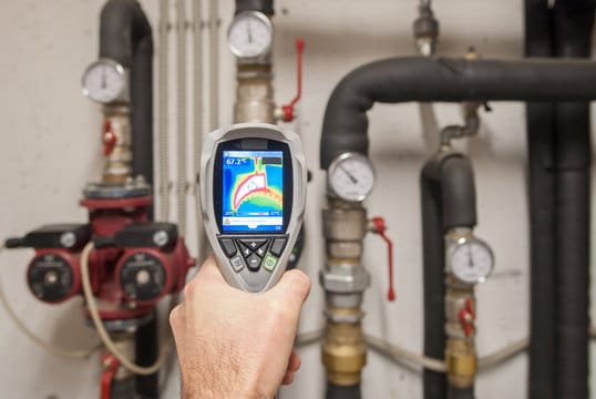 Plumber using a thermal imaging camera to inspect pipes in Wildwood