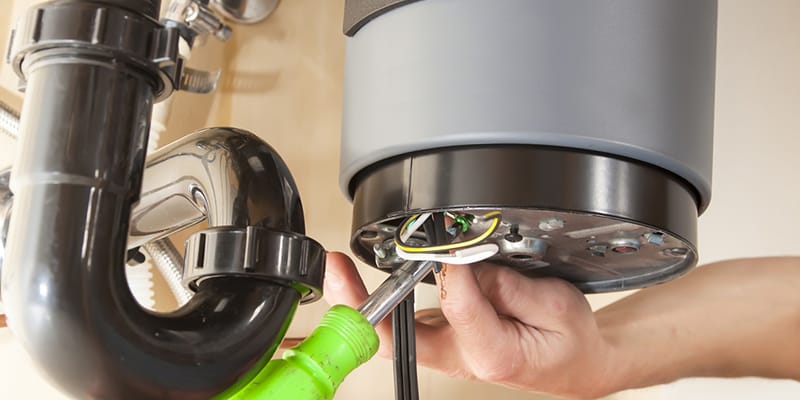 Technician repairing the heating element of a water heater in Wildwood
