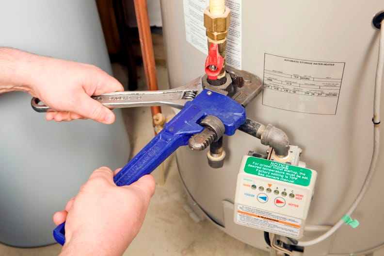 Plumber repairing a water heater valve in Wildwood